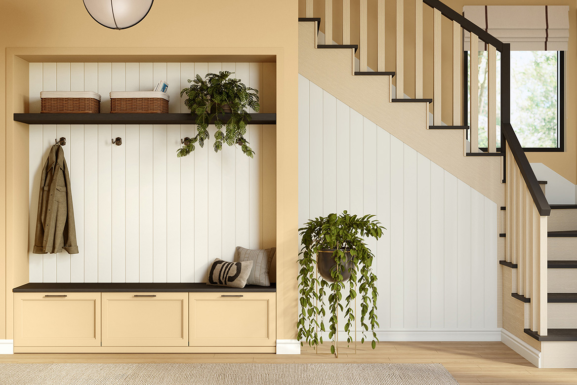 Spacious entryway with built-in bench in Warm Sunshine and paneled wall in Warm Milk. Stairway in soft neutrals.