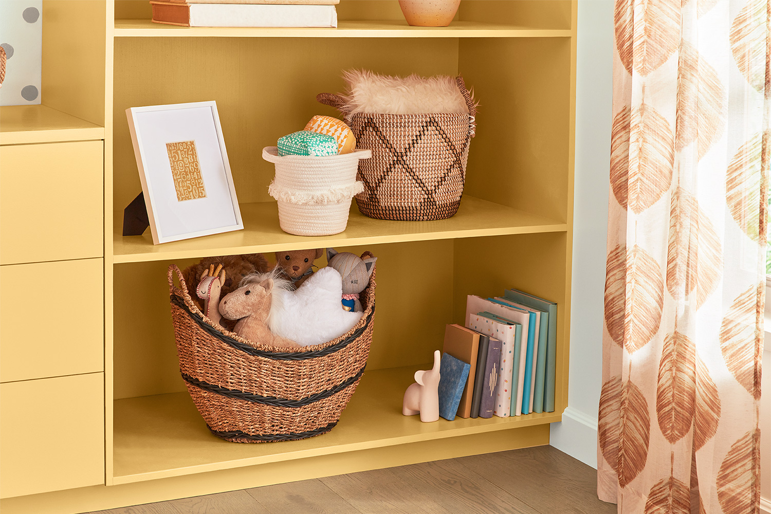 Delightful Moon bookshelf with basket of plush toddler toys, children’s books with elephant bookend.